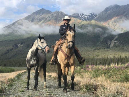 Cute Cowboy Traveling Alone - Trees, Scenic, Clouds, Smile, Cowboy, Filipe, Horses, Grass, Wild Flowers, Bridle, Haze, Saddle, Hat, Mountain Range