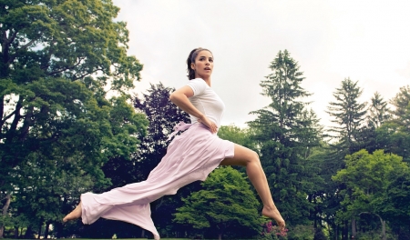 Aly Raisman - leaping, trees, violet skirt, brunette, white top