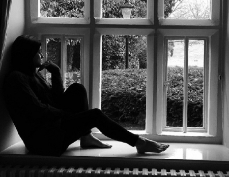 Christina Salti - siting on window sill, Brunette, bare feet, looking out of window, sweater, Black and white image
