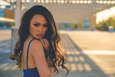 Tracie Dang-Perez - spaghetti straps, jewelry, blue dress, buildngs, brunette