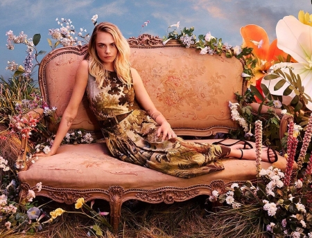 Cara Delevingne - posing on couch, fall colours pattern on dress, open toe black heels, brunette, belt