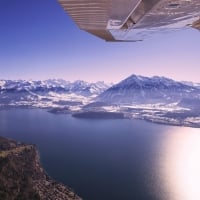 View from an airplane over a mountainside lake