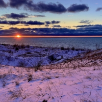 Sunset over snow-covered sand dunes, Berrien County, SW Michigan