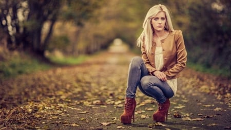 BLONDE ENJOYING HER WALK - DENIM JEANS, PATHWAY, RED BOOTS WITH HEELS, BLONDE, CAMEL JACKET, LEAVES