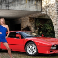 Model in a Blue Dress Posing with a Ferrari