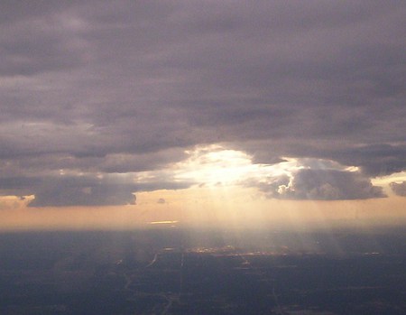 Bird's eye view  - sunbeams, sun rays, clouds, airplane view