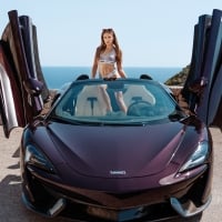 Talia Mint Posing with a McLaren