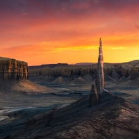 Strange spire rising out of the desolate badlands of Utah during a spectacular sunset