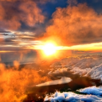 A golden sunrise marred by clouds over a Chinese mountain range