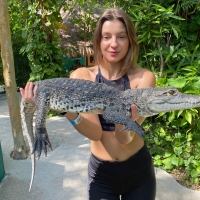 Maria Ryabushkina Posing with a Caiman