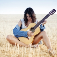 Cowgirl Strumming on her Guitar