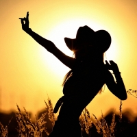 Cowgirl Silhouette at Sunset