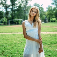 Blonde outdoors posing in a Pale Blue Dress