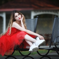 Blonde Wearing a Red Dress and Sneakers