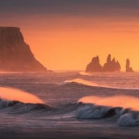 Golden waves at the sea stacks of Vik in Iceland