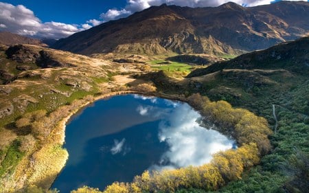 Heart Lake - sky, valley, trees, heart, water, mountains, terrain, gold foliage, lovers, clouds, rock, grass, shrubs, land, heartshaped, lake, landscape, mountain, new zealand, daylight, day, heart lake, place, nature, picture, shape, forest, blue, beautiful