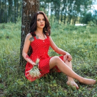 Model Posing in a Red Polka Dot Dress