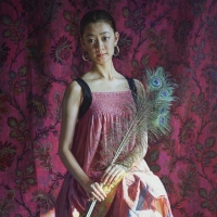 Girl with peacock feathers