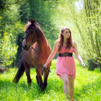 Cowgirl in the forest with her horse