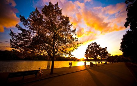 RELAXING ZONE - relax, people, walking, evening, benches, dog, sunrise, reflection, walk, dawn, bike, animal, riverbank, bench, lake, golden, sitting, sky, walkway, clouds, trees, water, beautiful, stroll, tree, river, nature, sunset, autumn, bicycle