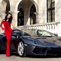 model in long red dress with her Ferrari