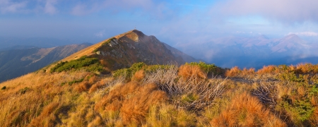 Autumn landscape with mountain peak - dry grass, hill, slope, travel