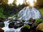 Sun rising over Diamond Creek Falls, Oregon