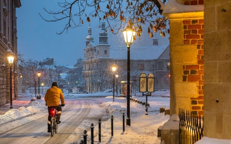 The First Snow in Krakow - street, lanterns, evening, rider, Poland, church, bicycle, Krakow, snow