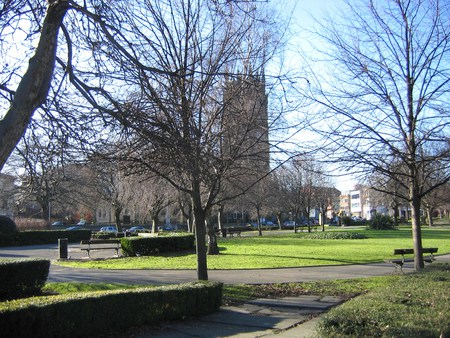 Winter morning in Leeds UK - seats, trees, church, grass