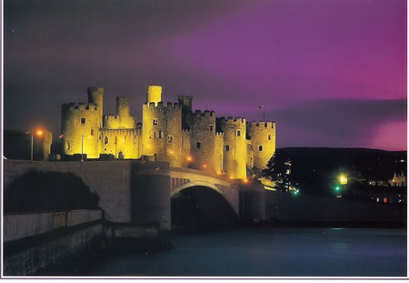 Conway Castle at night - colours in the sky, water, lights, bridge