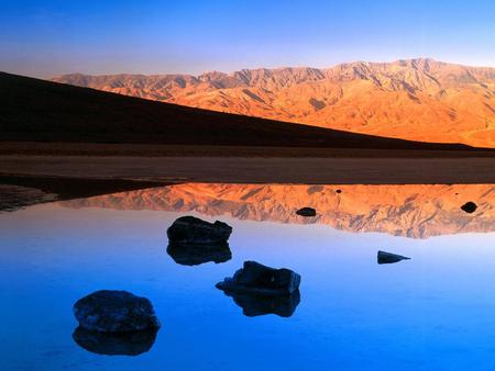 Dawn - reflections, lagoon, blue, rivers, amazing, sunsets, dawn, mirror, nice, sky, sunrises, water, beautiful, reflected, cool, orange, stones, mounts, nature, awesome, lakes, mountains, rocks