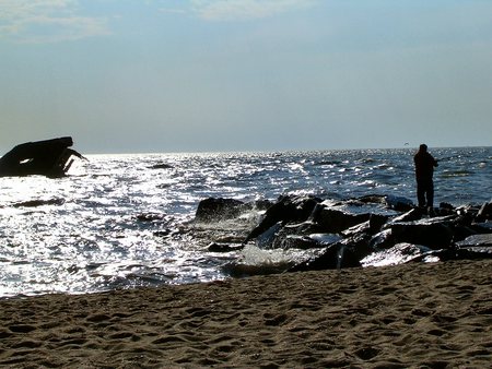 Fishing from a jetty - shining sea at sunset beach jetty, great for saltwater fishing