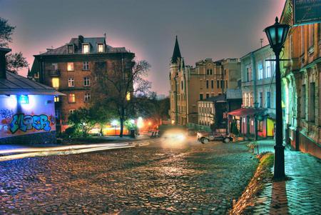 Night scene - street, cobble stone, light, homes, graffiti, buildings, lamp post