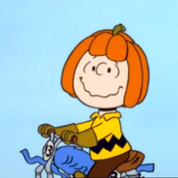 charlie brown in bike wearing a pumpkin hat