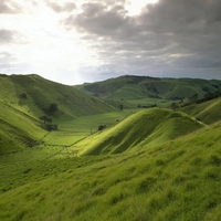 Green hill and sun in dark sky