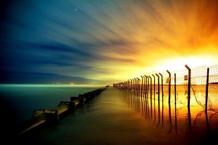 The Eternal Fence - fire, sky, coast, sunset, sea, sun, blue