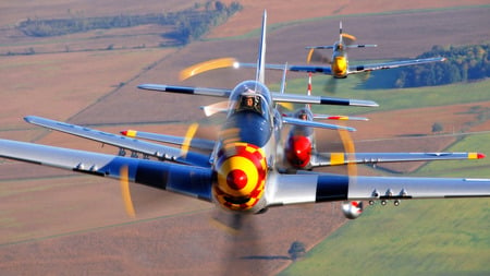 P-51 Mustangs over the English countryside 