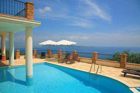 Corfu villas - water, relaxing, blue, beautiful, chairs, tiles, pillars, overlooking, pool, balcony, sky, umbrellas