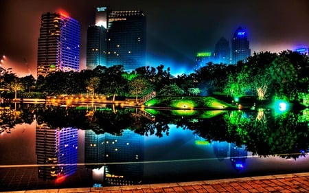 Night Neon - white, reflections, lakes, constructions, lagoons, purple, modern, yellow, tread, reflected, cities, pave, buildings, neon, mirror, pink, sky, trees, parks, water, paving, black, scarlet, floor, architecture, green, orange, rivers, monuments, houses, sign, night, plants, violet, gold, red, blue, city, colors, lights