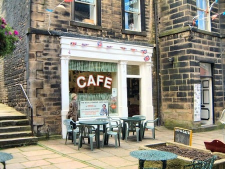 Cozy cafe - stairs, windows, building, sidewalk, bricks, chairs, tables, man, store, cafe