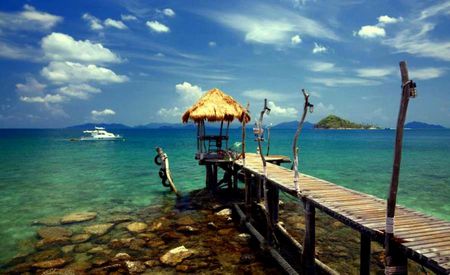 Solitude - clouds, tiki hut, boat, table, sea, dock, yacht, umbrella, mountains, rocks