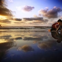 Boy Playing on the Beach at Dusk