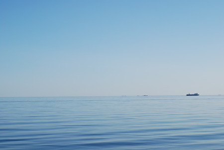 The boat tells the difference between sky and ocean - ocean, blue, boat