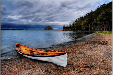 Canoe - clouds, trees, shoreline, beach, grass, ocean, dirt, lake, sky, rocks, canoe