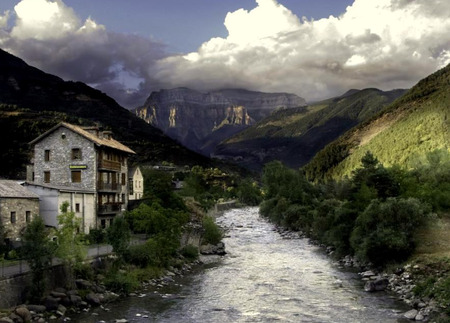 The River Flows - clouds, hills, shrubs, bushes, river, treees, mountains, houses, rocks