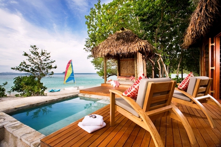 Beachfront patio - hut, ocean, beach, sail, trees, straw, pillows, sunglasses, chairs, boards, deck, lounges, towels, house, patio, pool