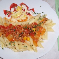 Colored Rigatoni Dish with Bolognese sauce and salad