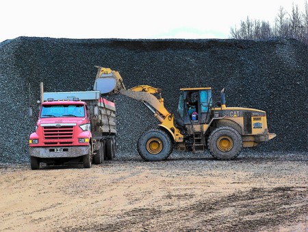 heavy equipment at work - truck, loader, stone