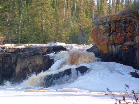 Spring thaw on the river - ice, waterfalls, rocks, river