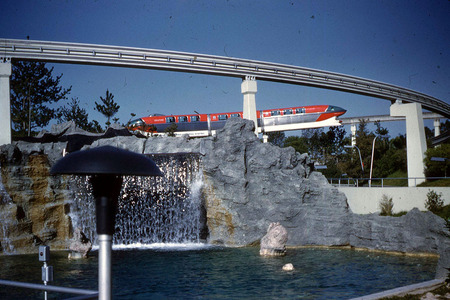 Old Red Monorail Going Over the Falls - disney park, monorail